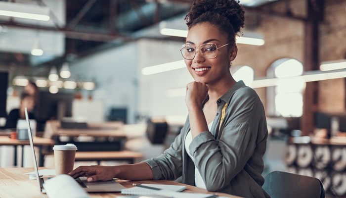 afro american girl working on laptop at modern office