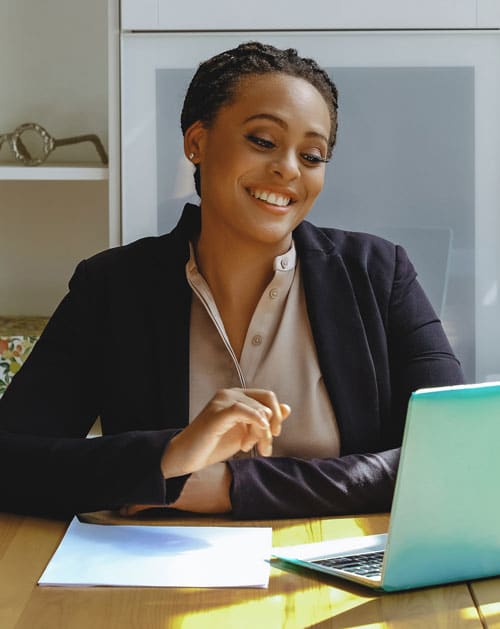 Black woman on a video call attending a backlin party