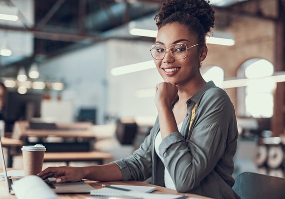 afro american girl working on laptop at modern office